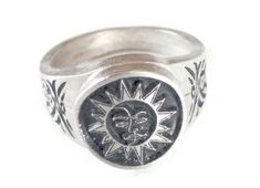 This ring was designed with the Sun, Moon & Face symbol. The sun symbolizes strength, firmness and power while the moon represents beauty, nurturing and calmness. The beautiful pewter ring is a silver color and the background is blackened to bring out the fine detail of the design. Our rings are 100% Lead and nickel free pewter and made in the USA The top design part of the ring measures about 15 mm in diameter The ring band tapers from about 15mm to about 4.5mm at the bottom and is about 1.75mm Adjustable Silver Ring With Sun And Moon Design, Silver Sterling Sun Design Ring, Pewter Ring, Accessory Inspo, Face Ring, Moon Face, Eye Of Horus, Southwestern Style, One Ring