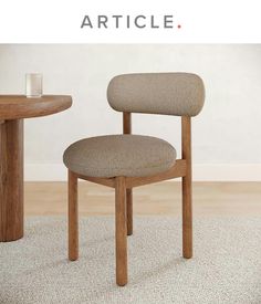 a chair sitting on top of a rug next to a table