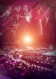 a large group of people sitting on top of a stage in front of a crowd