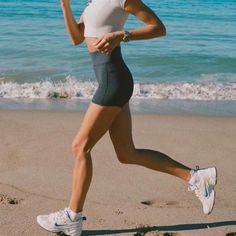 a woman is running on the beach