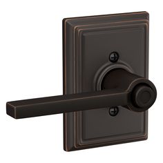 an image of a door handle and knob on a wall mounted light switch in dark bronze