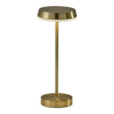 a brass table lamp on a white background