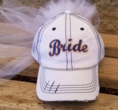 "Custom Bride Hat for Baseball Bachelorette Party or Bridal Shower- Customized to match her favorite team font and colors! I can match any team Makes a perfect gift for Bride! My Baseball theme Bride caps come with veil and customized in her favorite Baseball Team Colors. Perfect accessory to wear to a bachelorette party/bridal shower at a Baseball Game! Team Bride Hats also available message me for package deals@ OTHER BRIDE HAT STYLES AVAILABLE CLICK HERE https://www.etsy.com/shop/CapsbyKari?s Customizable White Hats For Sports Events, Personalized White Trucker Hat For Sports Events, Personalized White Baseball Cap For Sports Events, Customizable White Hats For Fan Gear, Adjustable Customizable Sports Fan Hat, Customizable White Baseball Cap For Sports, Customizable White Trucker Hat For Sports Fans, Baseball Bachelorette Party, Baseball Bachelorette