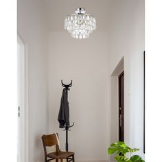 a room with a chair, coat rack and umbrella