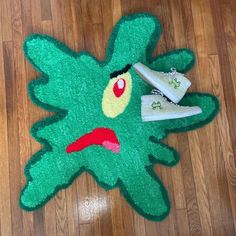 a green rug with a pair of sneakers on it