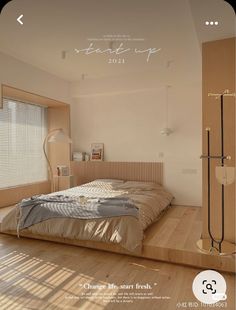 a bed sitting on top of a wooden floor next to a window