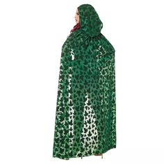 a woman wearing a green and white raincoat with an animal print pattern on it