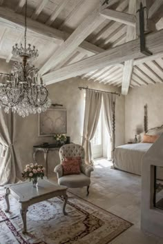 an elegant bedroom with chandelier and furniture