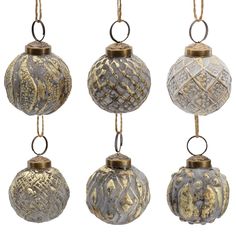 four ornaments hanging from chains on a white background