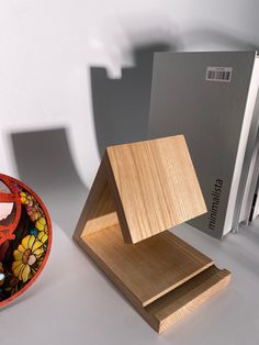 a wooden object sitting on top of a table next to a bag