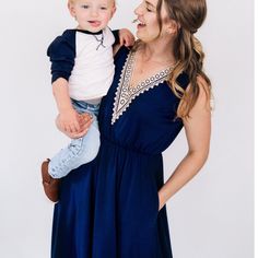 WOMEN'S- Mom's knee length dress is made with silky soft navy blue cotton like fabric with a small percent of spandex making them stretchy and comfortable. Convenient side pockets, a stretchy elastic waist for an easy pullover fit, and an elegant off-white lace accent adorns the bust of each dress. . SON- Dress your sweet boy in a smart 3/4 length sleeved shirt. The navy and light beige color creates the perfect matching piece to go with the women's dress for a mommy and son set you will love getting complimented on. Perfectly coordinated outfits for your next family photoshoot! Blue Cotton Dress With Side Pockets, Stretch Dresses With Side Pockets For Spring, Spring Stretch Dresses With Side Pockets, Spring Dresses With Side Pockets And Stretch, Fitted Blue Dresses With Side Pockets, Elegant Blue Dresses With Elastic Waistband, Blue Midi Dress With Elastic Waistband, Blue Cotton Dress With Elastic Waistband, Mommy Son