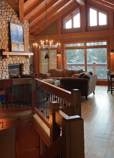 a living room filled with furniture and a fire place in the middle of an open floor plan