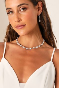 Any occasion that calls for the Lulus Elevated Luxury Silver Rhinestone Pearl Necklace and Earring Set is sure to be a glamorous and memorable event! This stunning jewelry set starts with a dazzling silver necklace that features a series of rhinestone-embellished medallions with shiny faux pearl centers. The matching earrings boast a drop silhouette with slender chains accented with clear rhinestones and the same eye-catching medallions at the ends for a posh finish. Hoco Necklaces Silver, Bridesmaid Silver Jewelry, Wedding Jewelry For Bridesmaids, Makeup For Silver Jewelry, Sparkling White Gold Necklaces For Parties, Sparkling White Gold Necklace For Party, Glamorous Bridal Necklace With Sparkling Stones In Diamond White, Glamorous Diamond White Bridal Necklace With Sparkling Stones, Party Bridal Necklace In White Gold With Sparkling Stones