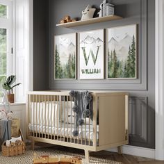 a baby's room with two posters on the wall and a crib in front of it