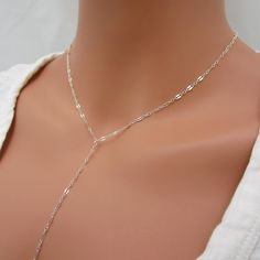 Made of solid sterling silver, the dainty lace chain makes this y-style necklace stand out. The drop portion of the chain measures approximately 5 inches long. Please leave a note at checkout if you want this length changed. Necklace closes with a spring-ring clasp and includes a 1 inch extension chain for an adjustable fit.  925 sterling silver 1 inch extender added  spring ring clasp drop chain measures 5 inches  SIZING - PLEASE READ: Note that necklaces will fit differently depending on a person's size. Please measure. The drop portion is NOT included in total necklace length because it is a separate piece of chain.  RETURNS/EXCHANGES: Necklaces under 16 inches are NOT able to be returned/exchanged. Please measure yourself to be sure you don't order too short. Dainty Silver Chain Lariat Necklace, Silver Lariat Choker Necklace With Clavicle Chain, Elegant Sterling Silver Lariat Necklace With Chain, Silver Adjustable Backdrop Necklace With Clavicle Chain, Minimalist Lariat Choker Necklace With Delicate Chain, Minimalist Delicate Chain Lariat Choker, Minimalist Delicate Chain Choker Lariat Necklace, Minimalist Choker Lariat Necklace With Delicate Chain, Sterling Silver Clavicle Chain Lariat Necklace For Parties