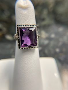 Art Deco Filigree work ring in 14K White Hold. This holds a beautifully cut Anethyst almost rectangular shaped stone. This is a finger size 4 1/2. This could be sized up 2 sizes. It's in immaculate condition.  Circa 1925 Weight 4.26 grams Stone approximately 5.00 carats. Classic Amethyst Ring With Rectangular Stone, Classic Amethyst Ring With Rectangular Stone For Gift, Formal Purple Rings With Rectangular Stone, Classic Emerald Cut Purple Rings, Rectangular Amethyst Ring For Formal Events, Rectangular Amethyst Ring For Formal Occasions, Classic Purple Emerald Cut Rings, Elegant Rectangular Amethyst Ring For Formal Occasions, Formal Purple Amethyst Ring With Rectangular Shape