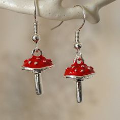 Make a statement with these pretty toadstool mushroom drop earrings for women. These cool quirky silver plated and enamel mushroom earrings are a great way to add a nice touch to your outfit. The charm on these toadstool mushroom dangle earrings measures at 1.7cm x 1.1cm and is attached to a silver plated hook. Please feel free to get in touch with us at Funky Earrings UK if you have any questions. We also have a wide range of other cute and unusual earrings in our shop. Toadstool Mushroom, Earrings Funky, Mushroom Earrings, Funky Earrings, Unusual Earrings, Earrings For Women, Jewelry Earrings Dangle, Women's Earrings, Silver Plated