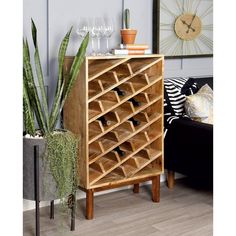 a wooden wine rack sitting next to a potted plant