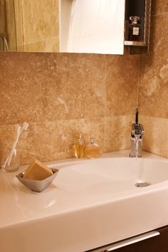 a bathroom sink with soap dispenser and toothbrushes on the counter