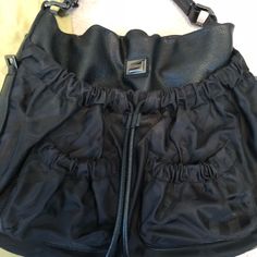 Black Burberry Hobo Bag. Front And Back Pockets Have Black On Black Check. Lightly Worn. Bag Is In Great Condition And Was Stored Inside The Dust Bag That Is Included With Purchase. Leather Looks Barely Worn. Burberry Hobo Bag, Leather Looks, Burberry Black, Bags Black, Black On Black, Burberry Bag, Hobo Bag, Burberry, Dust Bag