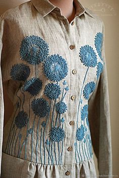 a woman's shirt with blue flowers on it