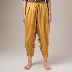 Get Mahashivaratri ready with Isha Life's bestseller unisex Dhoti pants. A popular choice among the Isha meditators, this versatile piece is stylish and comfortable. Made with 100% cotton, this ochre dhoti pant features the snake and vilva tonal print on its border. It has an elasticated waistband with a convenient fastener that allows you to experience the timeless charm of a classic dhoti in a ready-to-wear avatar. Dhoti Saree, Tonal Prints, Dhoti Pants, The Snake, Dresses Kids Girl, Three Piece, Mustard Yellow, Kids Dress, Best Sellers