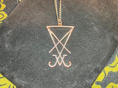 Dark times call for Darkness Jewelry. This custom-made rose gold Sigil of Lucifer / Seal of Satan is truly a sight to behold! Stainless Steel chain is one-size-fits-most and is also rose gold-colored. Show your support of The One behind all of this madness and be saved when He sets foot upon the land. Material: Stainless Steel, Steel Color: Rose Gold Dimensions: Necklace length = 18 inches, Pendant height = 38 millimeters, Pendant width = 22 millimeters Designed in the USA and hand-made in THAIL Symbolic Metal Clavicle Chain Jewelry, Symbolic Rose Gold Necklace, Rose Gold Stainless Steel Pendant Jewelry, Rose Gold Stainless Steel Pendant, Symbolic Rose Gold Pendant Jewelry, Rose Gold Symbolic Pendant Jewelry, Adjustable Rose Gold Metal Necklace, Rose Gold Stainless Steel Jewelry With Adjustable Chain, Rose Gold Jewelry With Adjustable Chain In Stainless Steel