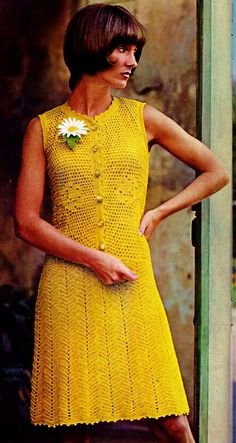 a woman wearing a yellow dress and flower in her hair