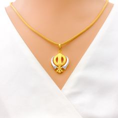 This tasteful Khanda pendant, made from 22k gold and weighing 3.8 grams, showcases an elegant dual-tone design with a primary yellow gold finish. Measuring 1.25 inches in length, it represents a blend of spiritual significance and contemporary style, embodying the essence of Sikh courage and remembrance. Ideal for those who appreciate symbolic jewelry with modern aesthetics, this dual-tone Khanda pendant is a meaningful addition to any collection, offering a touch of grace and tradition. PRODUCT DETAILS Gold Purity(karat): 22k Gold Weight(grams): 3.8 Item Finish: Yellow Gold Pendant Length: 1.25" Chain: Not Included Bridal Jewelry Necklace, Precious Stones Rings, Diamond Pendant Sets, Modern Bracelets, Mens Gold Rings, Fancy Necklace, Fancy Rings, Diamond Necklace Set, Traditional Earrings