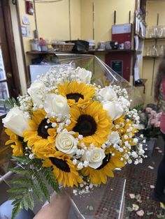 a bouquet of sunflowers and white roses