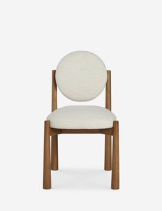 a white chair with wooden legs and a round back