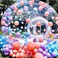 an inflatable bubble filled with lots of balloons