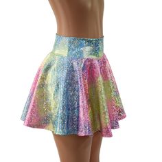 Rainbow shattered glass print holographic mini skirt. Choose your own length on this circle cut skirt, and you are ready to dance the night away in a dazzling sparkle of rainbow colors! It has a soft, spandex waistband (elastic free) that sets at the natural waist. . Choose from 10", 12" or 15" lengths!  The length shown is 15" Matching crops and halter tops are also available in our shop! Need help choosing "Length"? Watch this video: https://www.youtube.com/watch?v=qTKmmJGrjW8&t=1s Womens Sizi Metallic Mini Skirt For Summer, Spring Party Rave Skirt, Spring Rave Party Skirt, Rave Skirt For Spring Party, Iridescent Bottoms For Summer Party, Rave Mini Skirt For Spring, Rave Style Skirt For Spring Party, Shiny Metallic Skirt For Summer, Rave Style Mini Skirt For Night Out