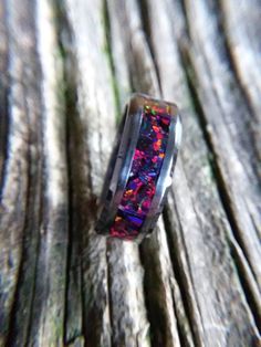 a wooden table with a ring that has been made to look like it is covered in colorful