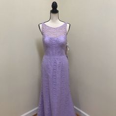 a purple dress is on display in front of a white wall