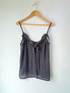 Comme des Garcons 2008 Black Sequin Cami! A sheer top that features black sequins along the collar and has spaghetti straps. 100% polyester. Dry Clean Only. Made in Japan. Marked a size medium. In excellent condition! Approx. Measurements: Underarm to Underarm: 19.5" Length: 25" Black Sheer Silk Tops, Evening Sequined Camisole Top, Sequin Camisole Top For Evening, Glamorous Sequined Camisole With Spaghetti Straps, Glamorous Sequined Spaghetti Strap Camisole, Sheer Silk Tops For Night Out, Sheer Silk Party Tops, Chic Sheer Tank Top For Party, Sequin Spaghetti Strap Top For Evening