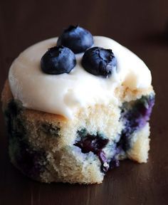 a close up of a blueberry cupcake with frosting