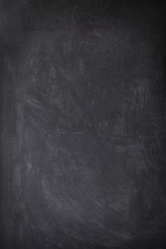 an apple sitting on top of a table next to a blackboard with writing on it