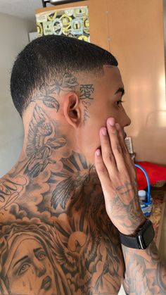 a man with tattoos covering his face and neck