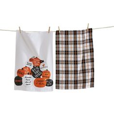 two tea towels hanging on a clothes line with pumpkins and words printed on them