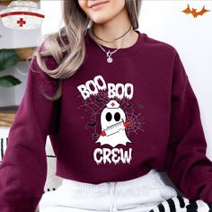 Boo Boo Crew Halloween Sweatshirt, Spooky Nurse Halloween Sweater, Boo Boo Ghost Nurse Sweat, Gift Cute Pullover For Nurse Squad Halloween 🌟 **Welcome to RaindropartsDesign 🌟 **Product Details Our sweatshirts are designed for durability and comfort, featuring high-quality materials and double-needle stitching. 👕 Unisex sizing for a relaxed fit 💫 Cozy blend of 50% cotton and 50% polyester 🔄 Reinforced with double-needle stitching for extra strength Our sweatshirts use the DTF (Direct to Film) printing technique, ensuring vibrant and long-lasting designs. **How to Order 1️⃣ Check out our product photos for all available options. 2️⃣ Choose your size and color from the dropdown menus. 3️⃣ Customize with your chosen text color. 4️⃣ Specify the quantity needed. 5️⃣ Click "Add to Cart" to c Red Long Sleeve Tops For Halloween, Red Long Sleeve Top For Halloween, Red Cartoon Print Sweatshirt For Fall, Halloween Long Sleeve Sweater With Letter Print, Horror Style Crew Neck Sweatshirt For Fall, Red Long Sleeve Sweatshirt For Halloween, Horror Crew Neck Sweatshirt For Fall, Boo Boo Crew Nurse, Horror Long Sleeve Sweatshirt For Halloween