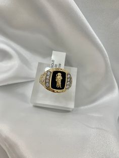 -14K San  Judas Ring  -100% Gold -Size 10.5  - Yellow gold  -Cubic zirconia  -Item sold by piece. Weight undetermined. Collectible Gold Diamond Ring With Brilliant Cut, Luxury Diamond Signet Ring Collectible, Gold Cluster Ring With 17 Diamonds, Collectible Yellow Gold Rings With Diamond Accents, Luxury Cubic Zirconia Signet Ring With Polished Finish, Luxury Gold Engraved Ring With Cubic Zirconia, Collectible Gold Rings With Diamond Accents, Cubic Zirconia Polished Signet Ring In Fine Jewelry Style, Fine Jewelry Cubic Zirconia Signet Ring With Polished Finish