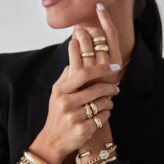 a woman wearing gold rings and bracelets