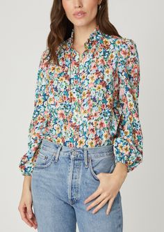 Cute, floral printed button-down blouse. This style features a high collar with small ruffle at the edge, button front placket, and full-length balloon sleeves with encased elastic at the openings. The body is loose for an easy fit. Unlined. Button front closure. 100% Polyester. Dry clean or hand wash. Color: Blue Multi Long Sleeve Sweater Dress, Denim Jumpsuit, Balloon Sleeves, Jacket Sale, Floral Printed, High Collar, The Edge, Bottoms Pants, Day Dresses