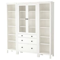 a white bookcase with glass doors and drawers on the bottom shelf is shown in front of a white background