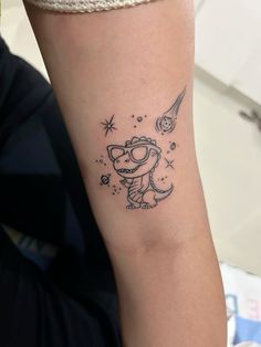 a small tattoo on the arm of a person with glasses and a star in the sky