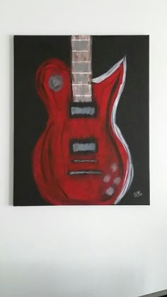 a painting of a red guitar hanging on the wall