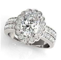 an oval cut diamond ring with pave set diamonds surrounding the band and center stone