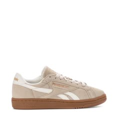 The 80s were a time of stylish footwear, and you can take your style back to those days in the Reebok Club C Grounds UK Women's Sneakers. Plus, with the perforations in the toe box, you'll reap the reward of added breathability. The suede material is soft and gives these that old-school feel, but the synthetic leather overlays take the style up a notch.Features: Perforations for breathability. Padded tongue and collar. Cushioned insole. Rubber midsole and outsole. Details: Lace-up. Materials: up Brown Reebok Shoes, Fall Sneakers Women, Neutral Sneakers Women, Creme Shoes, Trendy Sneakers For Women, Best Shoes For Women, Suede Set, Bangkok Shopping, Teacher Shoes