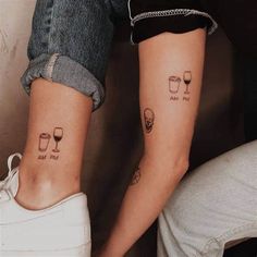 two people with matching tattoos on their legs